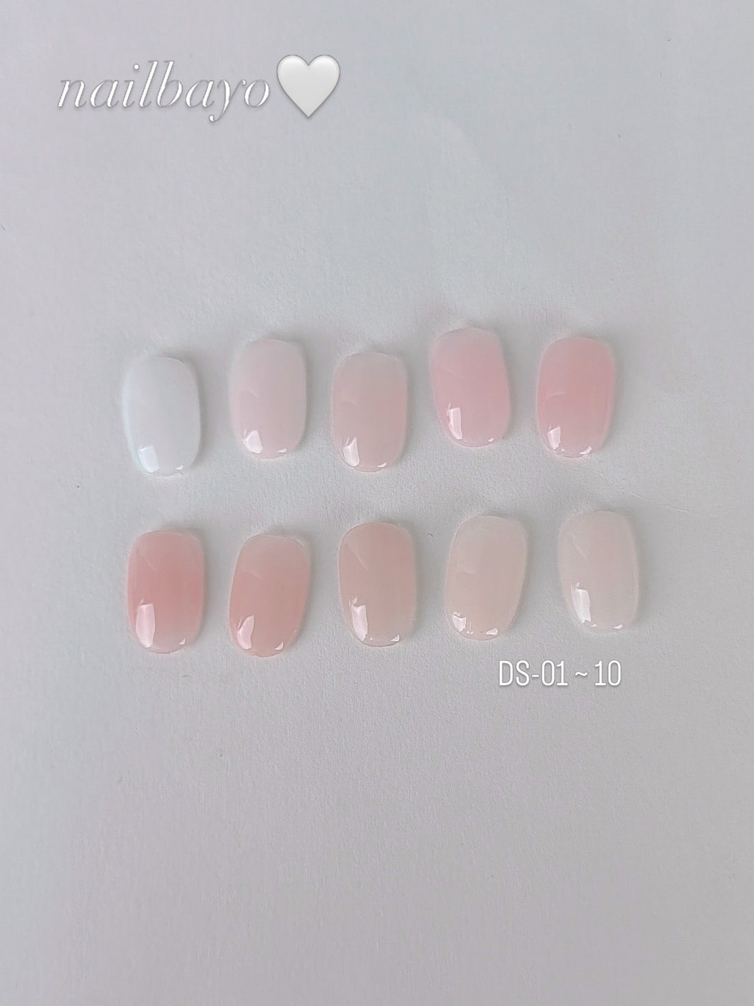 Nailbayo DOI renewed nude syrup range: ten glossy white, pink and nude nail swatches labelled DS01–DS10